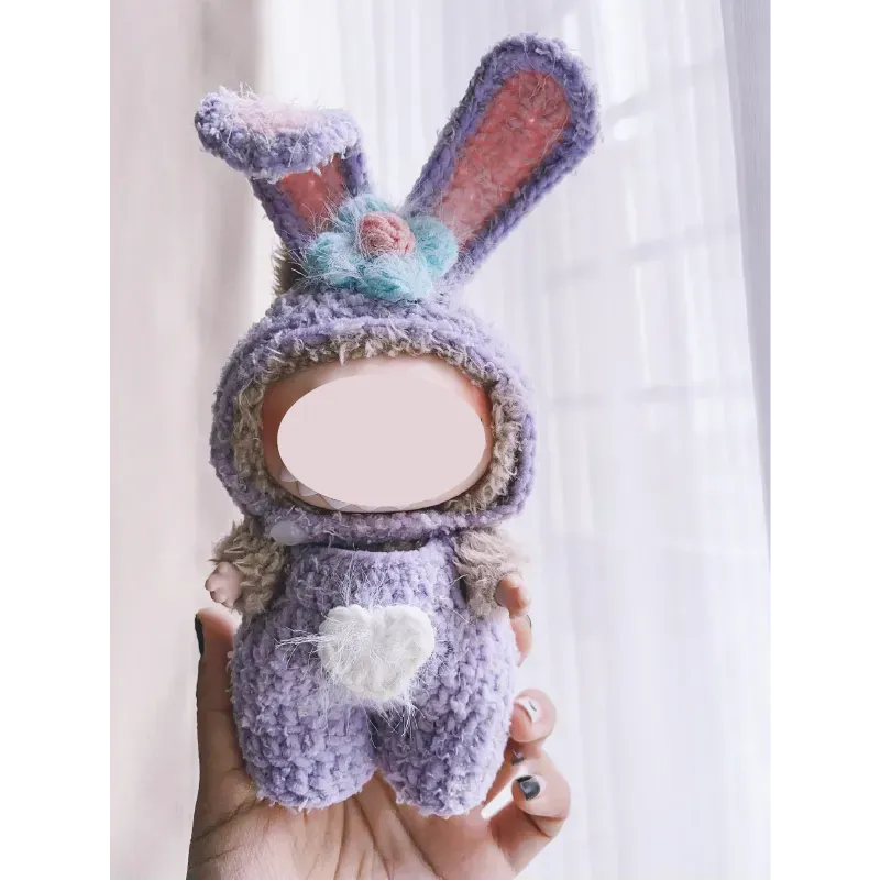 Hand holding a purple bunny outfit doll made with collectible crochet dolls pattern by The Knit Krazy