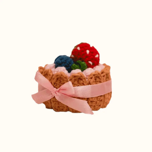 Handcrafted crochet biscuit cake with colorful berries and pink ribbon crochet biscuit cake pattern