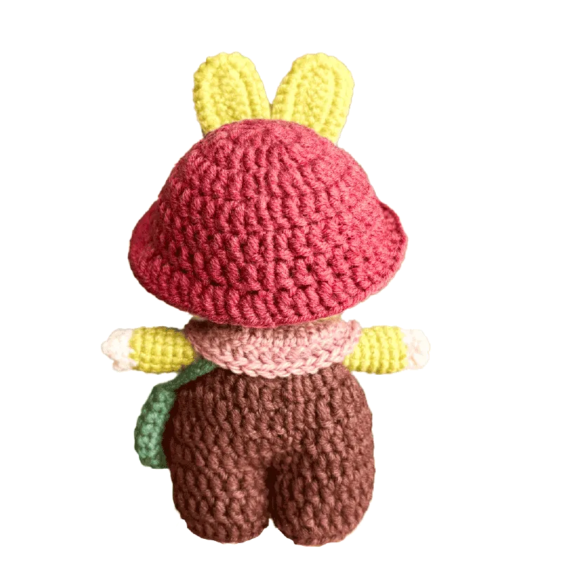 Handmade crochet bunny doll with pink hat yellow ears and brown pants by The Knit Krazy