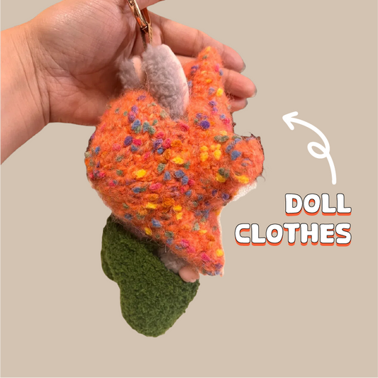 Hand holding colorful crochet fox doll keychain made with crochet doll outfit pattern