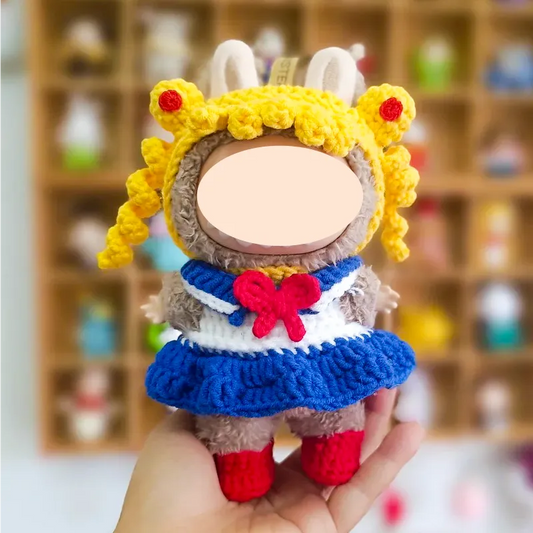 Handheld crocheted plush doll dressed in Sailor Moon inspired outfit with yellow hair and red boots