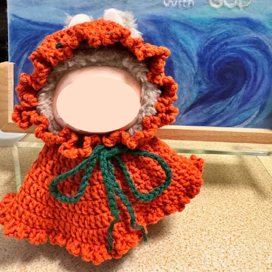 Handmade orange crochet DIY Halloween doll costume with green tie and textured ruffled edges