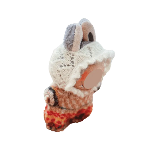 Handcrafted knitted doll wearing a detailed white lace bonnet and colorful romper using knitted doll romper pattern