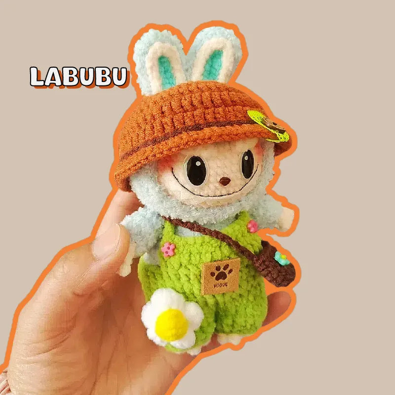 Hand holding a crocheted bunny doll with a brown hat and green outfit bunny crochet keychain pattern