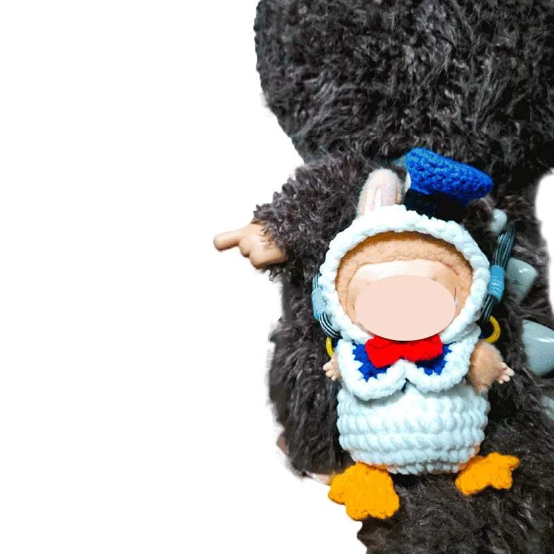 Cute baby wearing crochet Donald Duck bag pattern costume with blue hat and orange feet