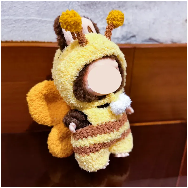 Playful bee knitwear for dolls in yellow and brown with fluffy antennae and wings