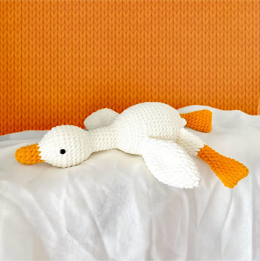 Handmade white and orange plush duck lying down knit from lazy duck amigurumi tutorial by redbook
