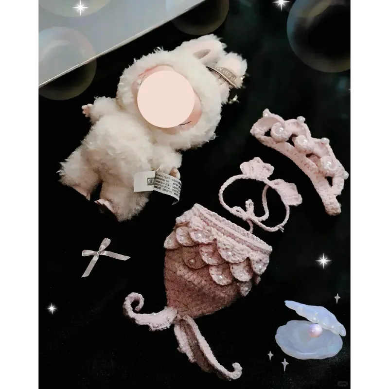 The Knit Krazy mermaid crochet doll pattern featuring a white plush doll with mermaid tail, crown, and accessories