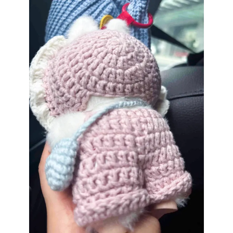 Handmade pink knit doll outfit featuring a detailed crocheted sweater and bonnet
