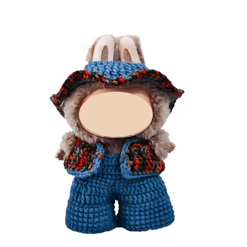 17cm plush doll wearing handmade blue crochet overalls and a matching hat from 17cm plush doll crochet clothes tutorial