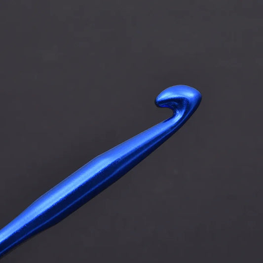 Close-up of a blue crochet hook from a rainbow aluminum crochet hooks set on a dark background