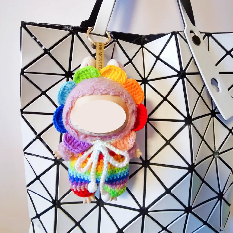 Rainbow crochet doll outfit pattern keychain attached to a black and white geometric bag