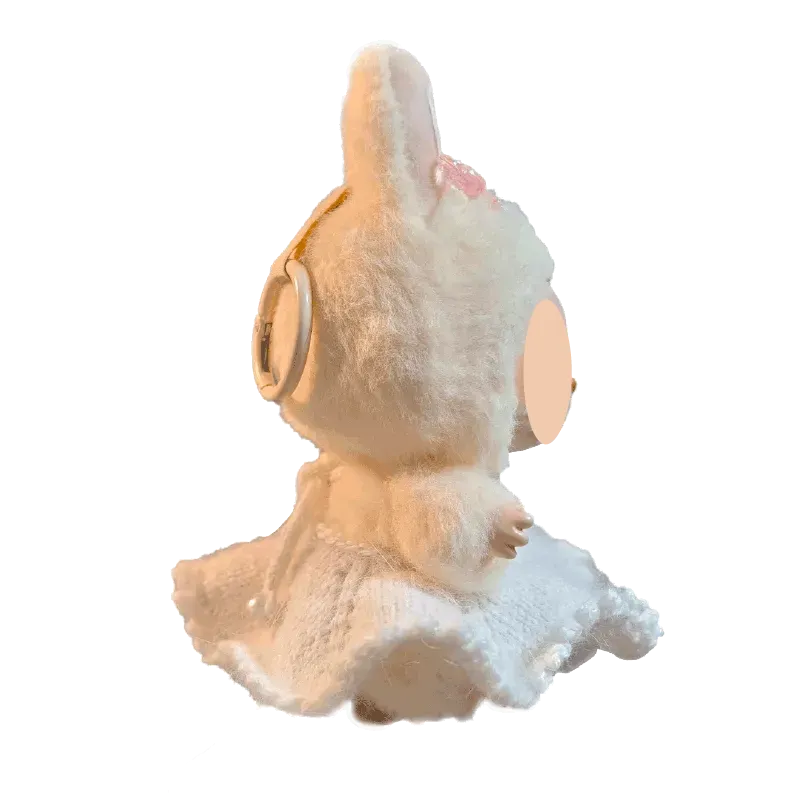Soft plush doll wearing a white dress with lace details from redbook digital download doll dress pattern
