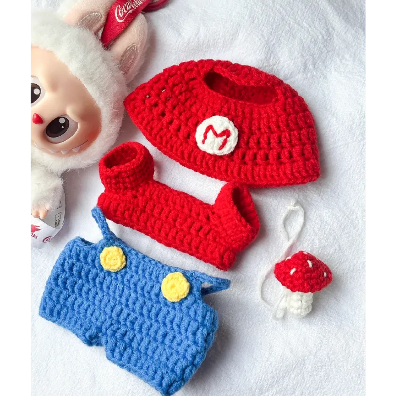 Redbook Super Mario crochet pattern with red hat, blue overalls, and mushroom keychain crocheted accessories
