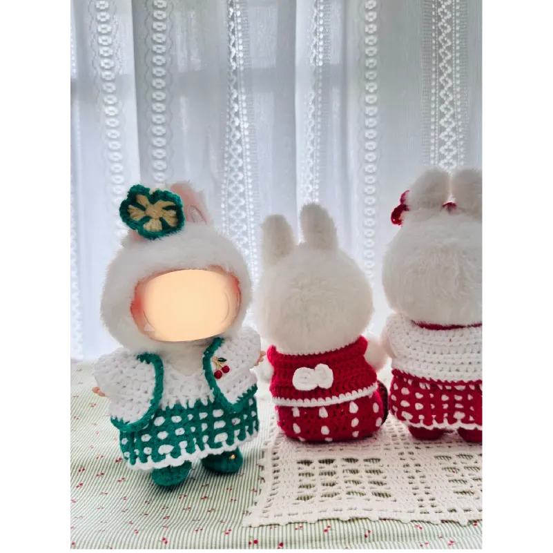 Sweetheart doll outfit pattern featuring handmade crocheted dresses in green and red on plush dolls