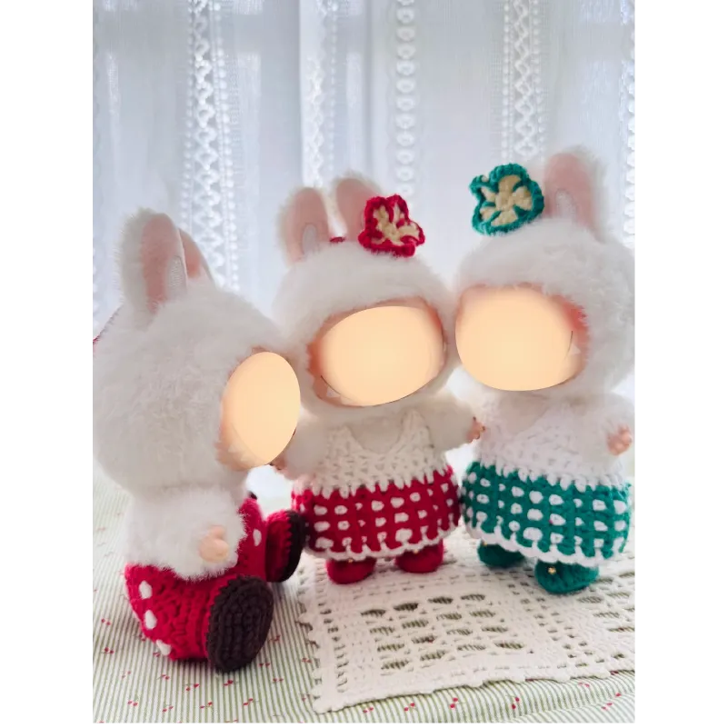 Three plush dolls wearing crocheted dresses featuring sweetheart doll outfit pattern by redbook