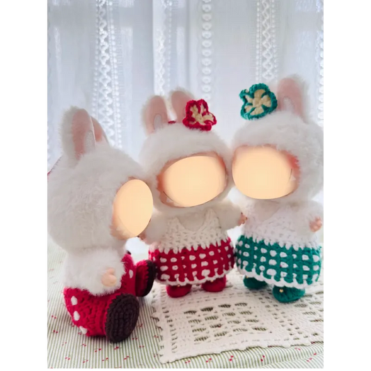 Three plush dolls wearing crocheted dresses featuring sweetheart doll outfit pattern by redbook