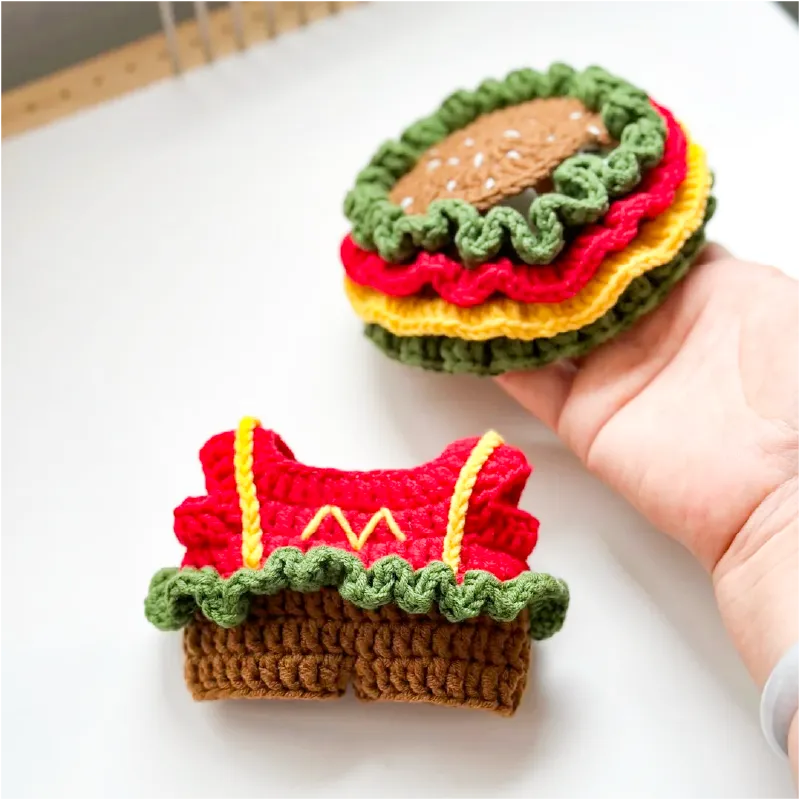 Handmade crochet burger toy with colorful layers and knit dress outfit by The Knit Krazy