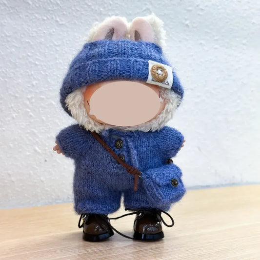 Black and white vintage doll outfit crochet pattern resembling a bird costume with a yellow beak