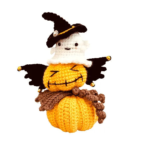 Crocheted pumpkin character with a witch hat on a white background