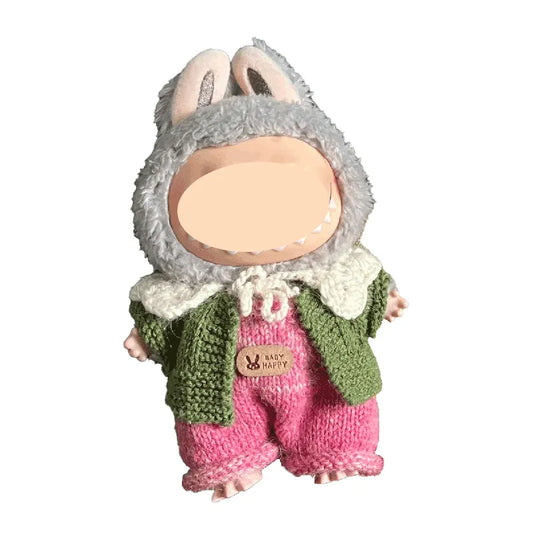 Toy figure of a rabbit wearing a knitted outfit on a white background
