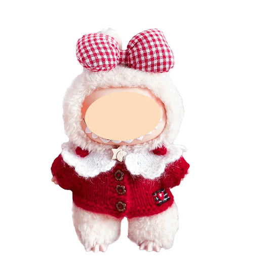 Small plush toy resembling a dog in a red sweater with a checkered bow on a white background