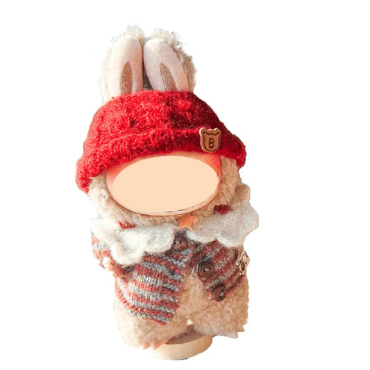 Decorative gnome with a red hat and striped scarf on a white background
