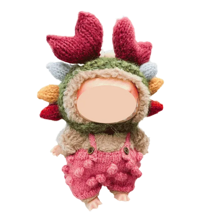 17cm crab flower knitted plush tutorial showing a small doll wearing a crab-inspired knitted hat and pink overalls