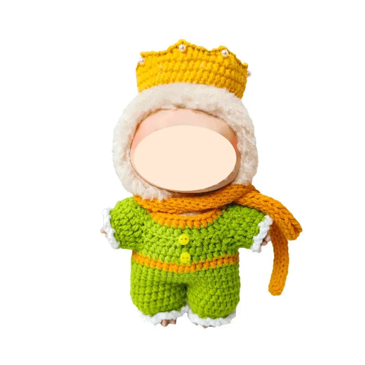 Knitted toy with a green outfit, orange scarf, and yellow hat on a white background