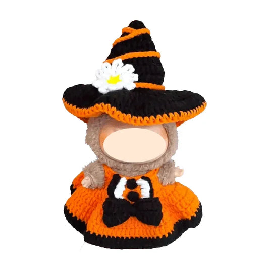 Plush toy dressed as a witch with an orange and black outfit on a white background