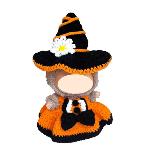 Crocheted dog sweater with witch hat and pumpkin design on a white background