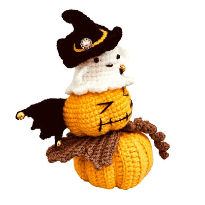 Crocheted scarecrow with a pumpkin body on a white background