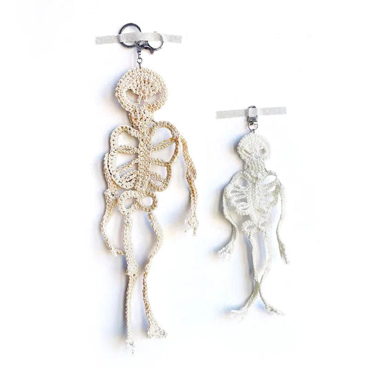 Skeletal design earrings on a white background