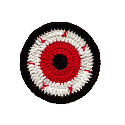 Circular patch with an eye design featuring red, white, and black on a white background