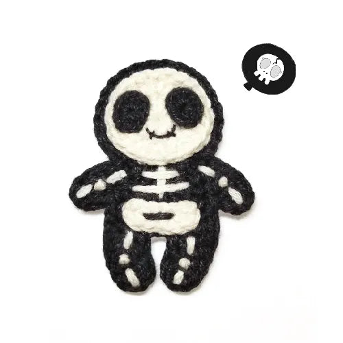 Black and white skeleton plush toy on a white background