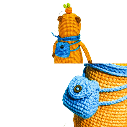 Handmade orange capybara amigurumi with a blue crocheted backpack from capybara amigurumi pattern