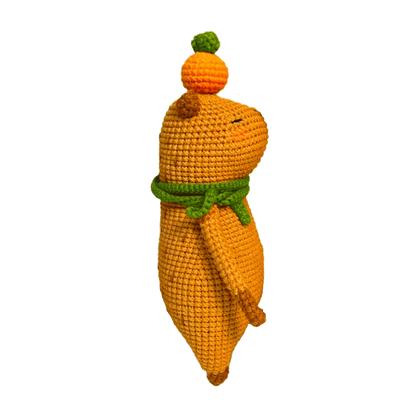 Colorful crochet doll keychain hanging on geometric black and white handbag capybara amigurumi pattern