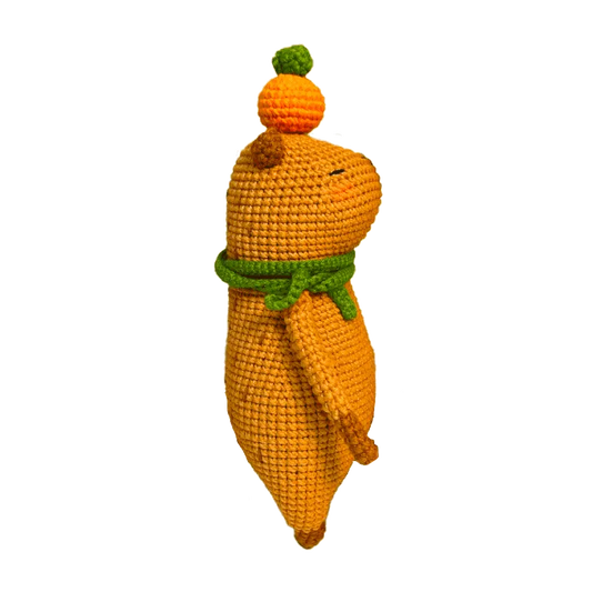 Colorful crochet doll keychain hanging on geometric black and white handbag capybara amigurumi pattern