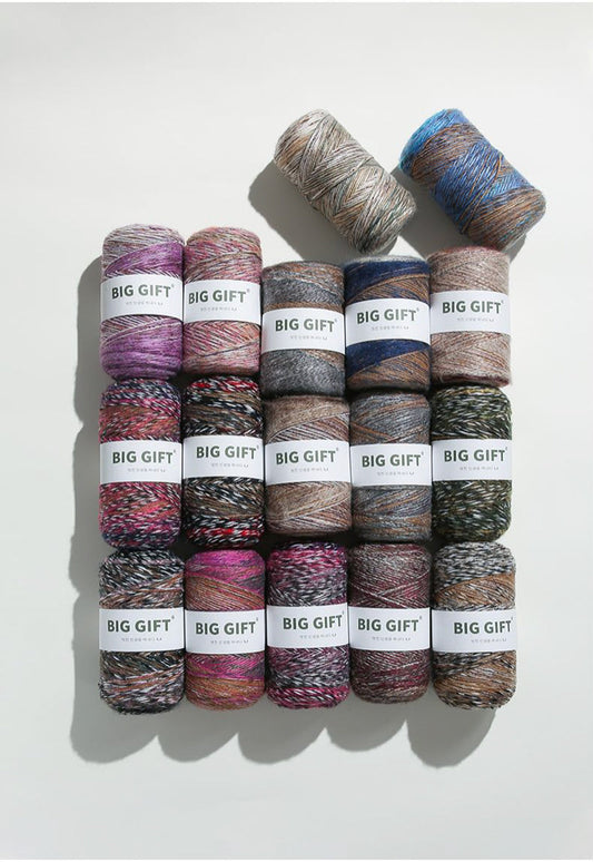 Assorted colorful yarn skeins labeled Big Gift made from artisan wool blend for crochet accessories
