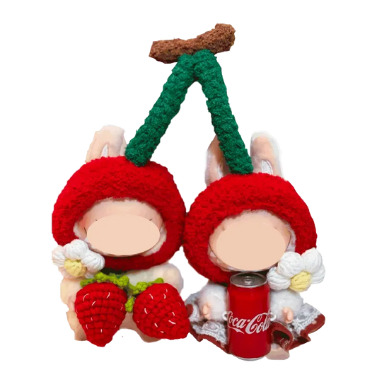 Cherry-themed crochet outfit for plushies featuring red cherry hats with green stems and white flowers
