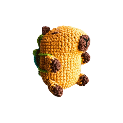 Handmade crochet capybara keychain pattern with brown and yellow yarn details on black background