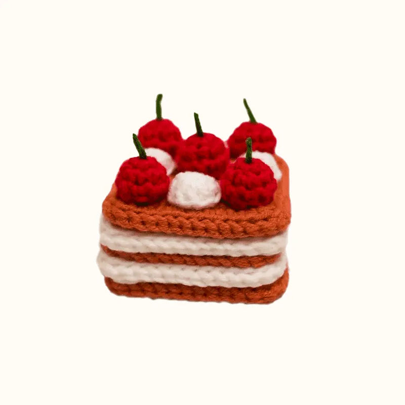 Crochet cherry cake pattern from The Knit Krazy showing a layered cake with red cherries and white cream