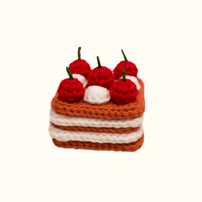 Crochet cherry cake pattern from The Knit Krazy showing a layered cake with red cherries and white cream
