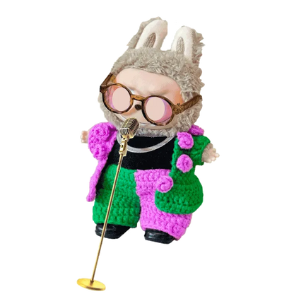 Crochet concert doll outfit pattern featuring a colorful green and pink textured suit with bunny ear hat and sunglasses