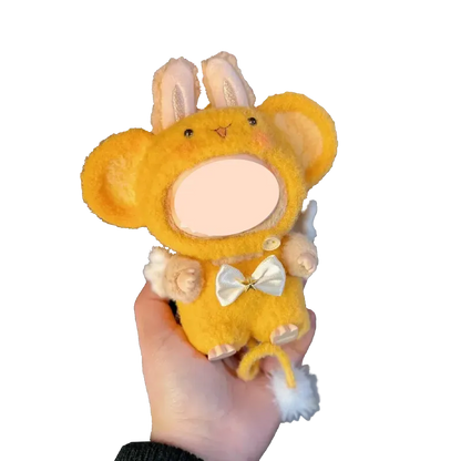 Hand holding a yellow plush toy wearing a crochet monkey outfit pattern with bunny ears and white bow
