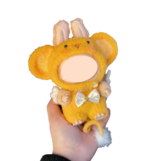 Hand holding a yellow plush toy wearing a crochet monkey outfit pattern with bunny ears and white bow