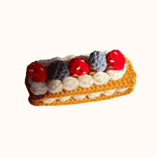 Crochet Napoleon cake pattern featuring layered cream and colorful berry details by The Knit Krazy