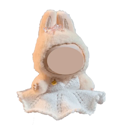 Cute doll wearing a white knitted bunny hood and dress from a digital download doll dress pattern