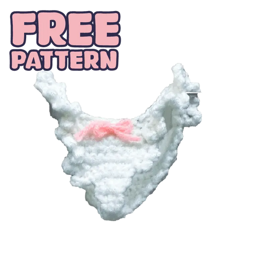 White crocheted doll panties with pink bow showcasing free-crochet doll panties pattern on black background