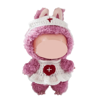 Cute handmade doll wearing a pink and white free crochet nurse outfit pattern with bunny ears